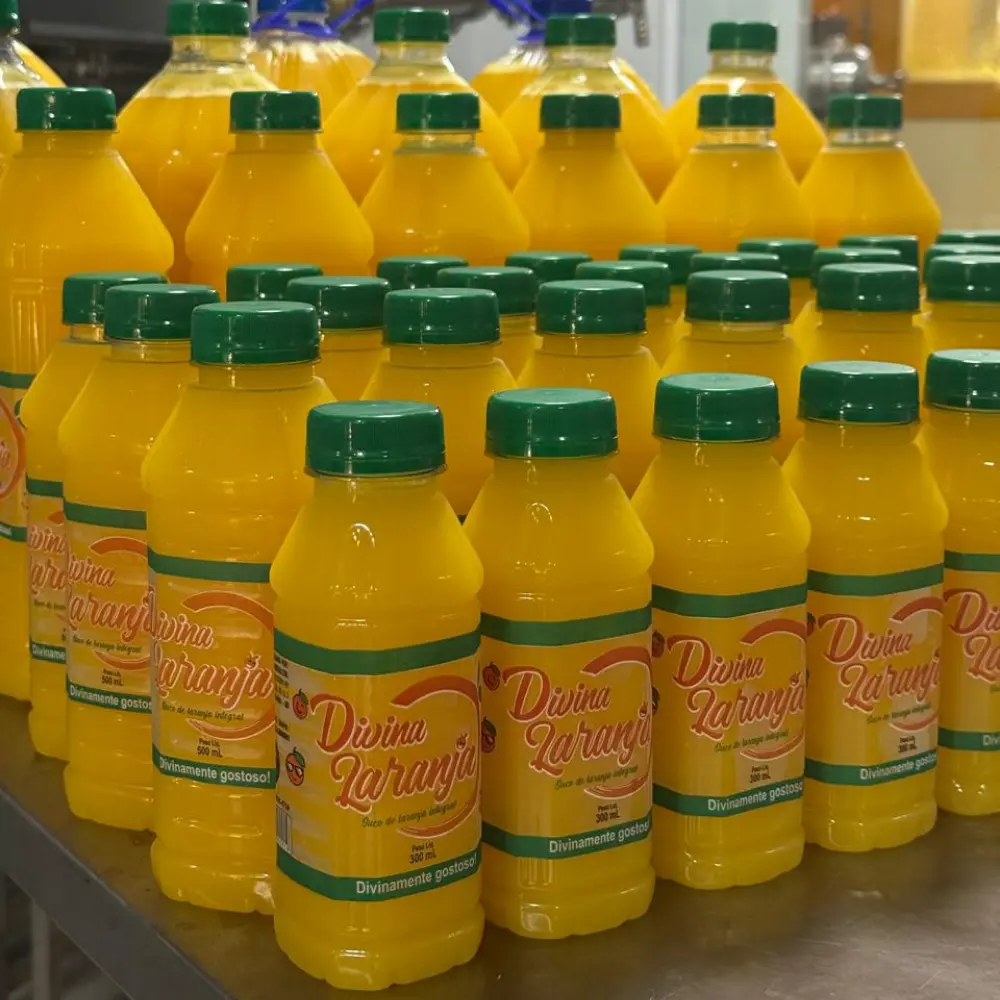 Grande volume de garrafas Divina Laranja na linha de produção